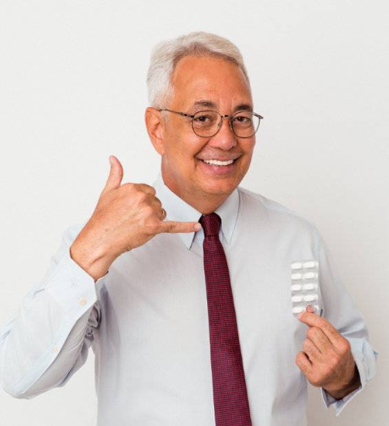 Senior american man holding pills isolated on white background showing a mobile phone call gesture with fingers.